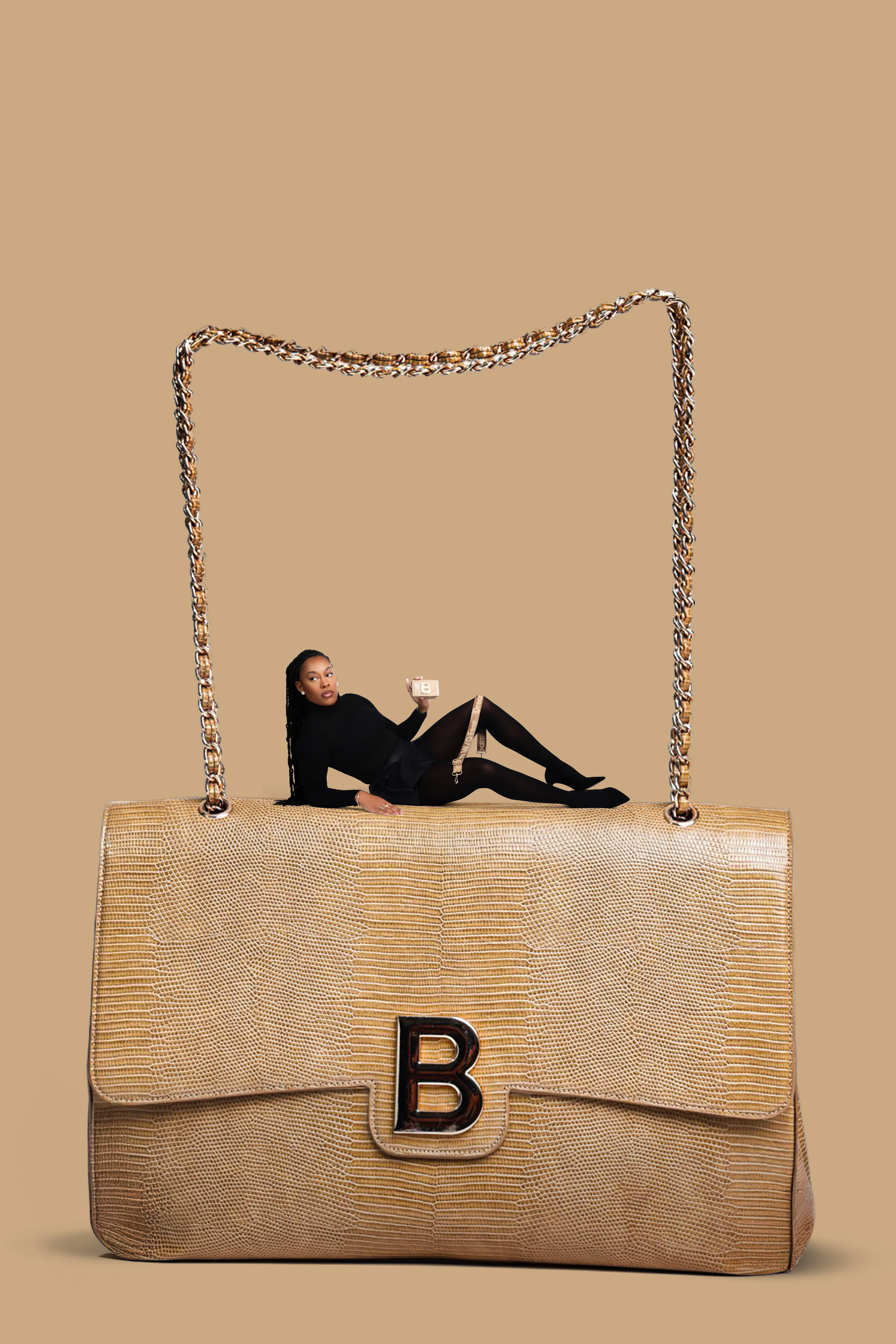 Gold croc-embossed structured luxury handbag with chain strap and premium hardware styled for high-fashion editorial photography.