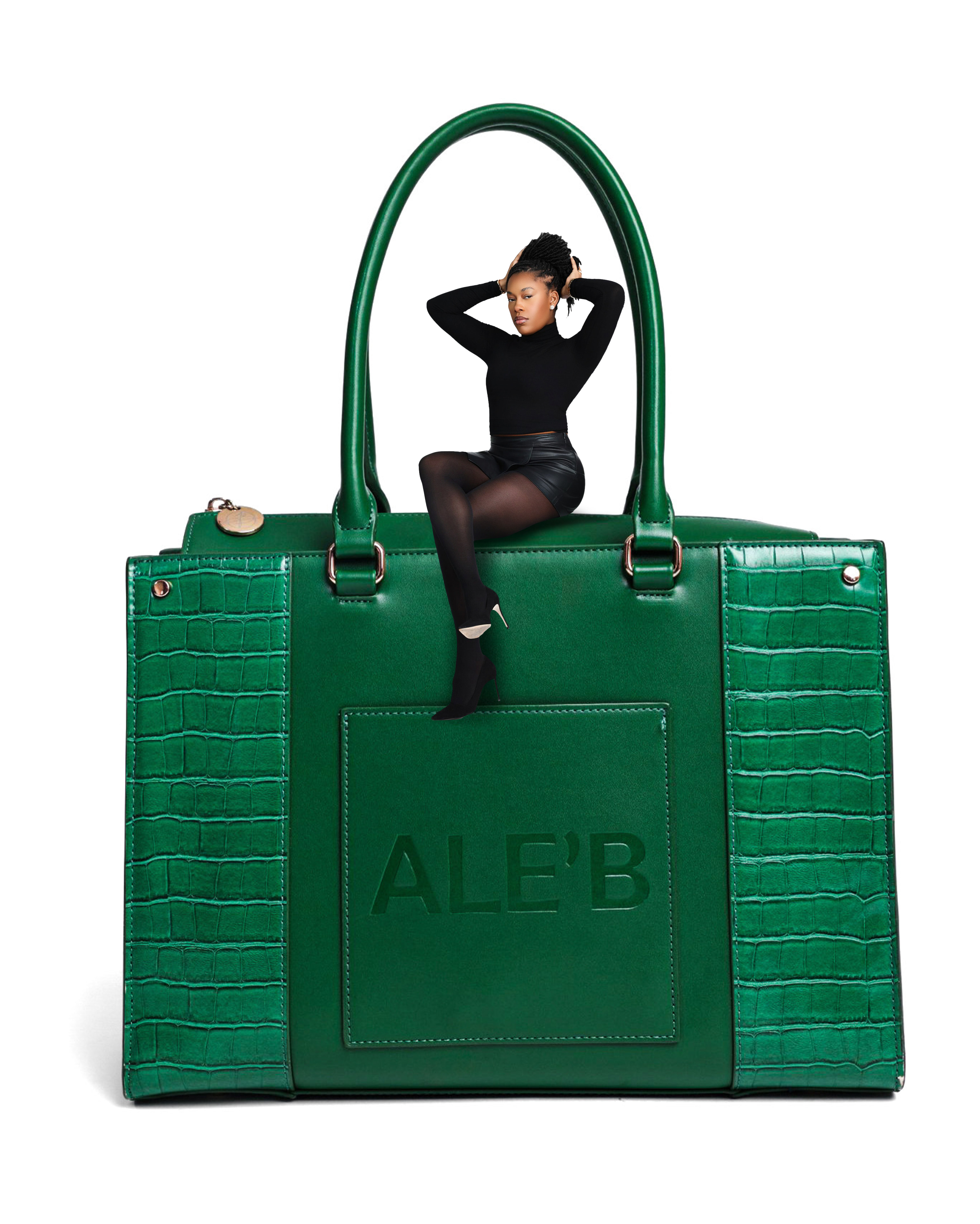 Emerald green structured luxury handbag with croc-embossed side panels and premium hardware, styled for high-fashion editorial photography.